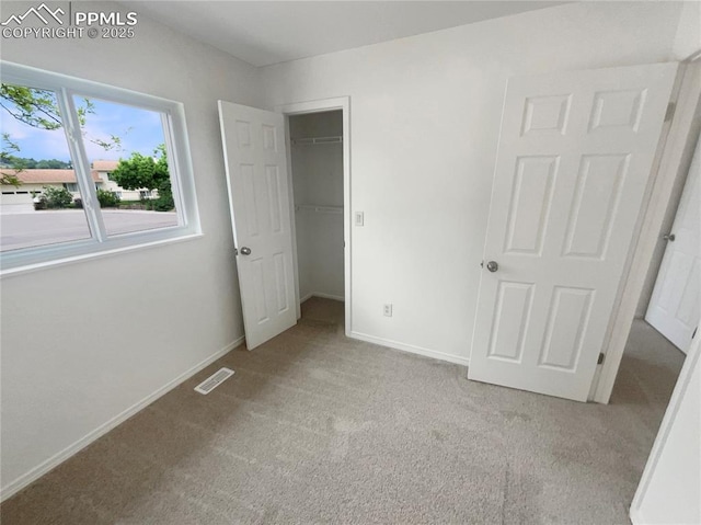 1995 Hampton, Colorado Springs, CO 80906 - unfurnished bedroom with carpet, baseboards, a walk in closet, and a closet