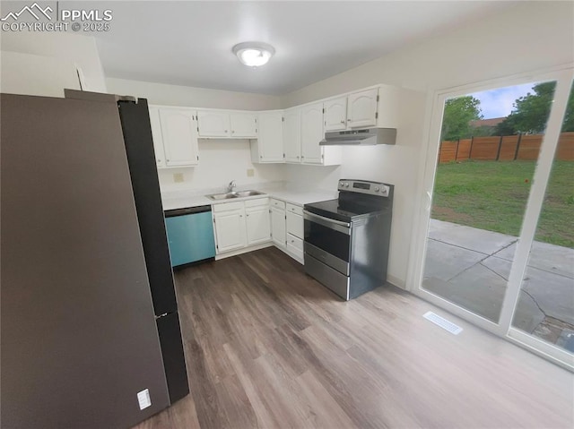 1995 Hampton, Colorado Springs, CO 80906 - kitchen featuring stainless steel appliances, a sink, under cabinet range hood, and white cabinetry