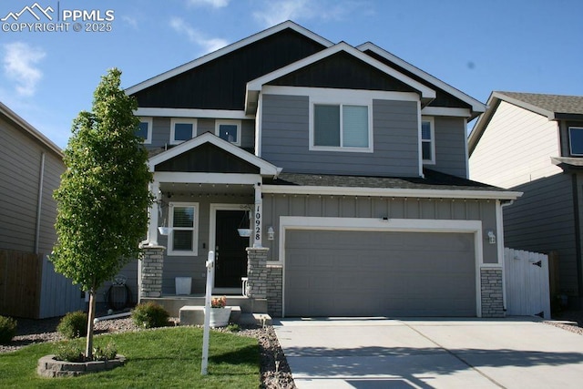 10928 Clarion Dr, Colorado Springs, CO 80925 - craftsman inspired home featuring board and batten siding, an attached garage, concrete driveway, stone siding, and roof with shingles