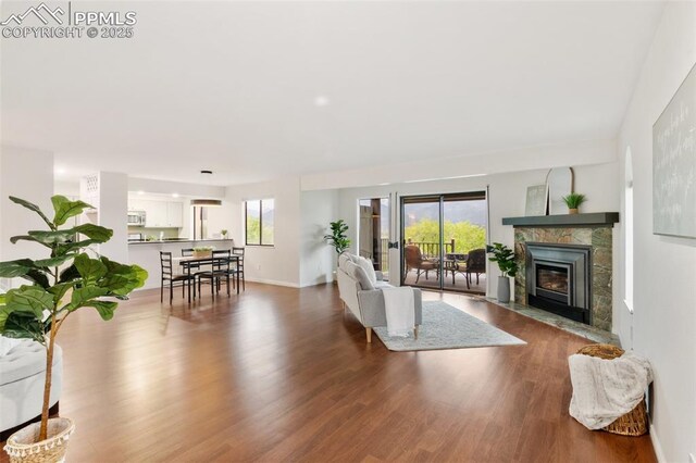 942 Fontmore Rd Unit B, Colorado Springs, CO 80904 - living room featuring wood finished floors, a fireplace with flush hearth, and baseboards