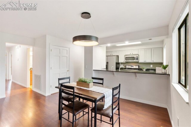 942 Fontmore Rd Unit B, Colorado Springs, CO 80904 - dining area with dark wood finished floors, baseboards, and healthy amount of natural light