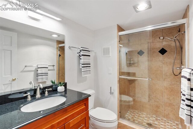 942 Fontmore Rd Unit B, Colorado Springs, CO 80904 - full bathroom featuring vanity, a stall shower, and toilet