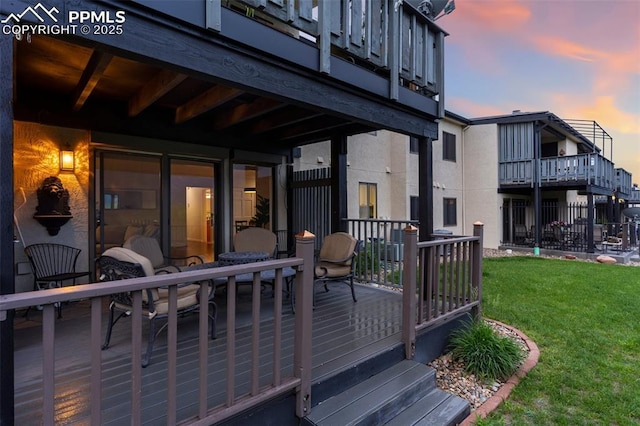 942 Fontmore Rd Unit B, Colorado Springs, CO 80904 - deck at dusk featuring a lawn