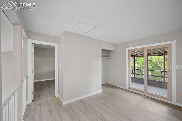 4408 Winding Cir, Colorado Springs, CO 80917 - unfurnished bedroom featuring access to outside, attic access, wood finished floors, and a closet