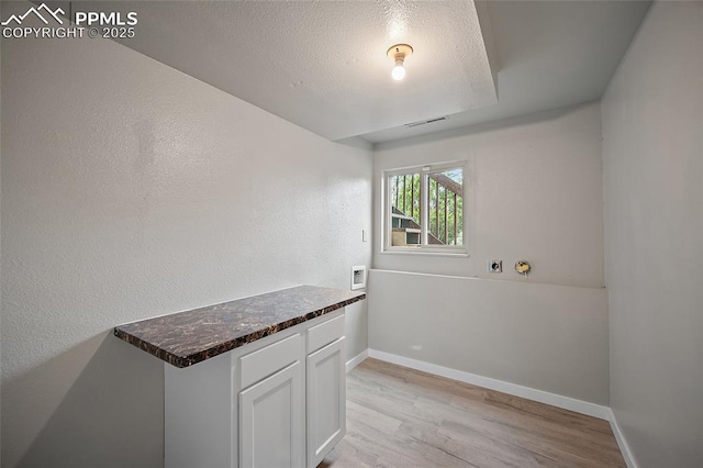 4408 Winding Cir, Colorado Springs, CO 80917 - laundry area with light wood-style flooring and a textured ceiling