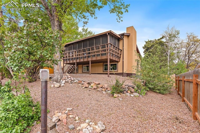 4408 Winding Cir, Colorado Springs, CO 80917 - rear view of property with a sunroom, stairway, a wooden deck, and stucco siding