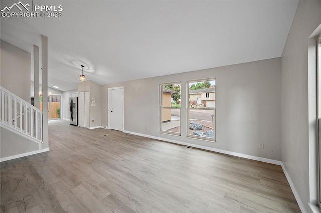 4408 Winding Cir, Colorado Springs, CO 80917 - unfurnished living room with wood finished floors and stairway