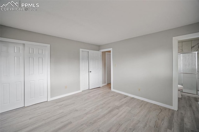 4408 Winding Cir, Colorado Springs, CO 80917 - unfurnished bedroom with wood finished floors, multiple closets, and ensuite bathroom