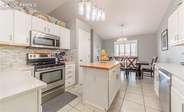 830 Winebrook Way, Fountain, CO 80817 - kitchen featuring stainless steel appliances, a chandelier, wood counters, decorative backsplash, and vaulted ceiling
