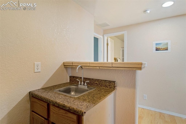 830 Winebrook Way, Fountain, CO 80817 - indoor wet bar featuring light wood-style floors and baseboards