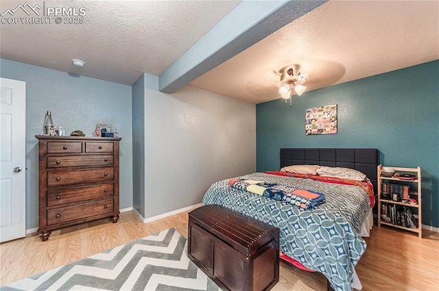 830 Winebrook Way, Fountain, CO 80817 - bedroom featuring wood finished floors, a textured ceiling, baseboards, and ceiling fan