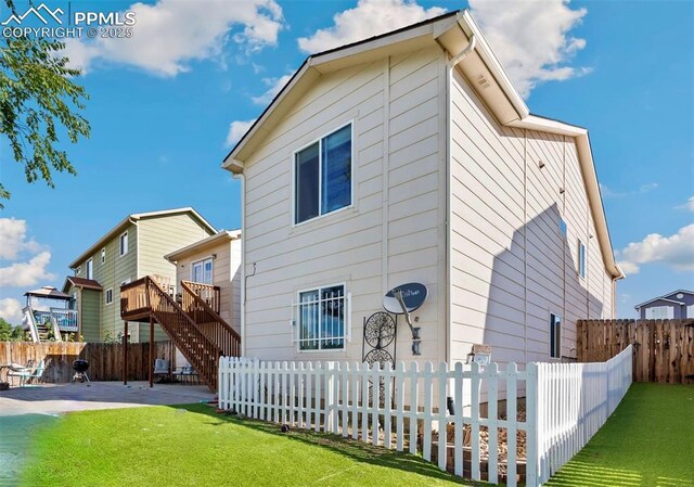 830 Winebrook Way, Fountain, CO 80817 - rear view of house with a patio, stairs, and a wooden deck
