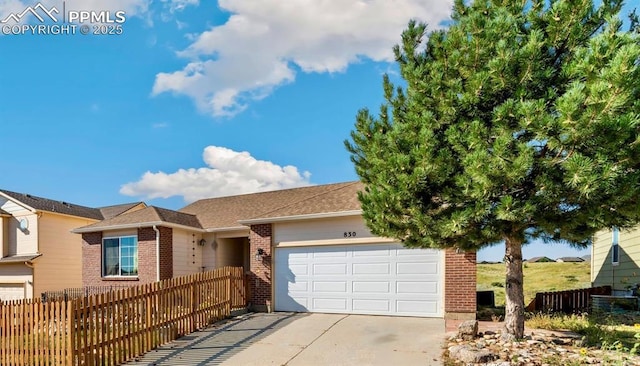 830 Winebrook Way, Fountain, CO 80817 - view of front of house with brick siding, an attached garage, concrete driveway, and a shingled roof