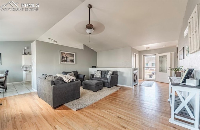 830 Winebrook Way, Fountain, CO 80817 - living room with light wood-style floors, ceiling fan, baseboards, and vaulted ceiling