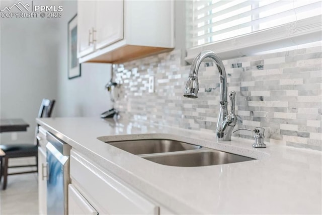 830 Winebrook Way, Fountain, CO 80817 - kitchen with a sink, backsplash, white cabinetry, and dishwasher