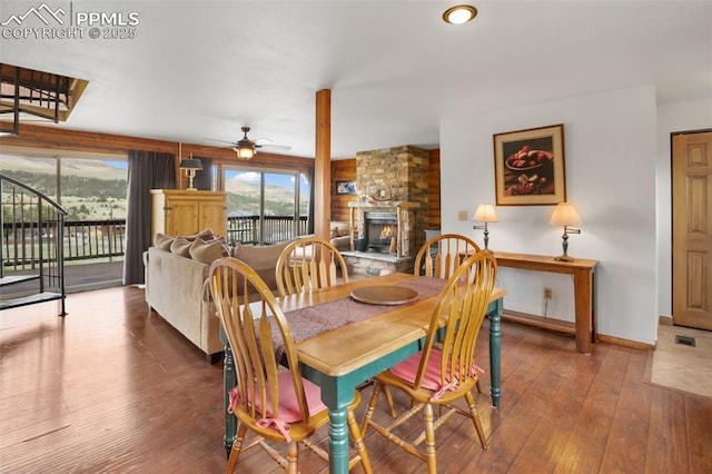 226 W El Paso Ave, Cripple Creek, CO 80813 - dining space featuring a fireplace, wood-type flooring, and a ceiling fan