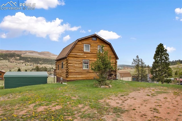 226 W El Paso Ave, Cripple Creek, CO 80813 - view of home's exterior featuring a barn, an outdoor structure, a gambrel roof, and a mountain view