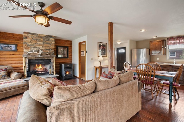 226 W El Paso Ave, Cripple Creek, CO 80813 - living area with dark wood-type flooring, a ceiling fan, and a fireplace