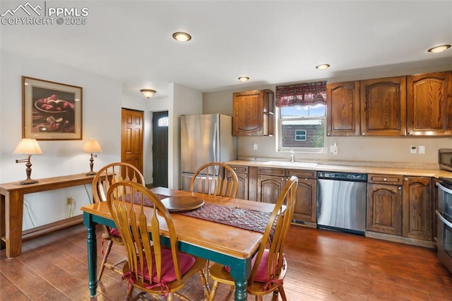 226 W El Paso Ave, Cripple Creek, CO 80813 - kitchen featuring appliances with stainless steel finishes, hardwood / wood-style floors, light countertops, brown cabinetry, and recessed lighting