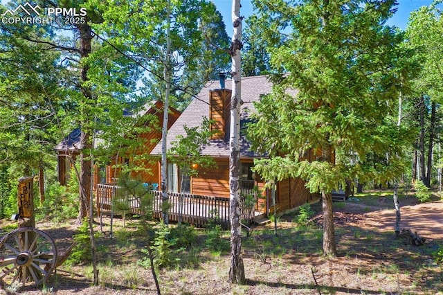 886 Cottonwood Lake Dr, Divide, CO 80814 - view of property exterior with a wooden deck and a shingled roof