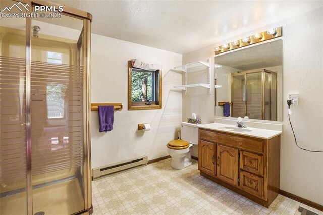 886 Cottonwood Lake Dr, Divide, CO 80814 - full bath with a baseboard radiator, vanity, a stall shower, tile patterned floors, and toilet