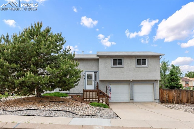 4303 W Eastcrest Cir, Colorado Springs, CO 80916 - view of front of home featuring an attached garage, driveway, and stucco siding