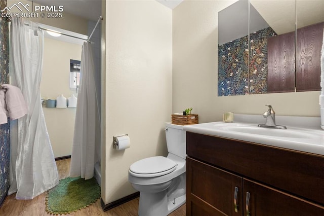 4303 W Eastcrest Cir, Colorado Springs, CO 80916 - bathroom with wood finished floors, vanity, toilet, and curtained shower