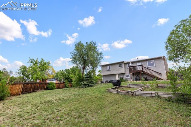 4303 W Eastcrest Cir, Colorado Springs, CO 80916 - view of yard featuring a garden, a deck, and stairs