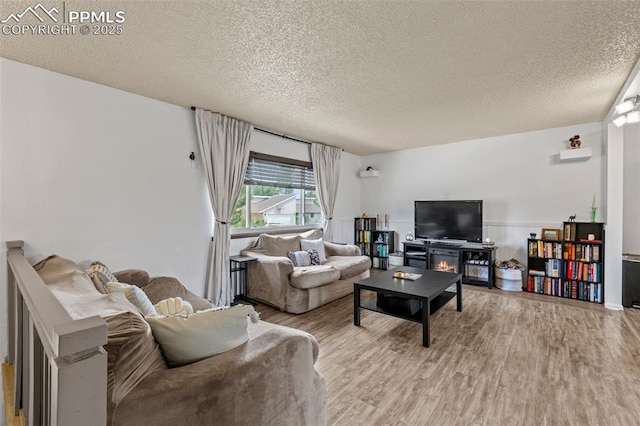 4303 W Eastcrest Cir, Colorado Springs, CO 80916 - living area featuring a textured ceiling and wood finished floors