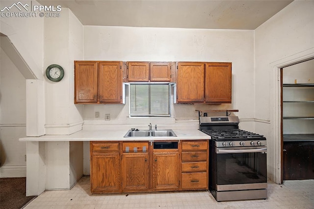 117 S Limit St, Colorado Springs, CO 80905 - kitchen featuring stainless steel gas range, a sink, light floors, and brown cabinetry