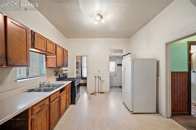 117 S Limit St, Colorado Springs, CO 80905 - kitchen with freestanding refrigerator, stainless steel gas range oven, a sink, and healthy amount of natural light
