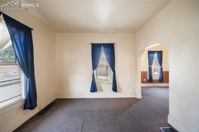 117 S Limit St, Colorado Springs, CO 80905 - carpeted spare room featuring arched walkways and baseboards