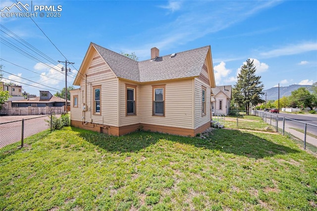 117 S Limit St, Colorado Springs, CO 80905 - view of side of home with roof with shingles, a chimney, and a mountain view