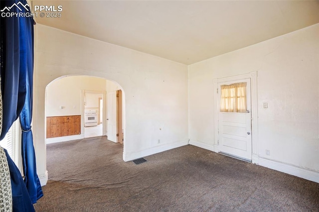 117 S Limit St, Colorado Springs, CO 80905 - carpeted spare room featuring arched walkways and baseboards
