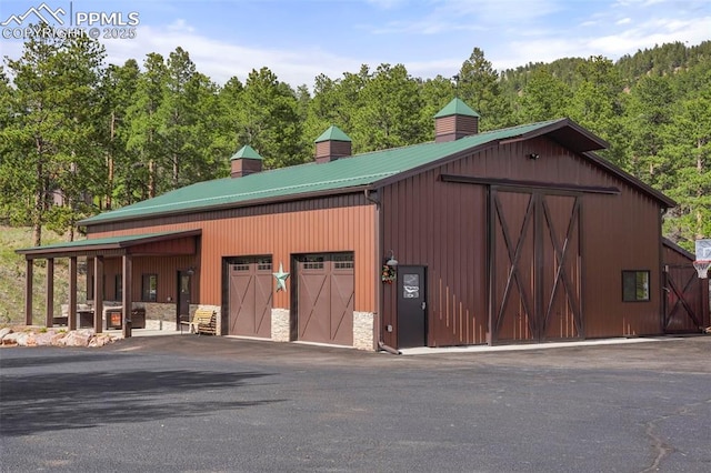 215 Morning Sun Dr, Woodland Park, CO 80863 - view of outbuilding with a view of trees