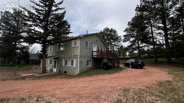 418 N Baldwin St, Woodland Park, CO 80863 - view of property exterior with a wooden deck, dirt driveway, and stairs
