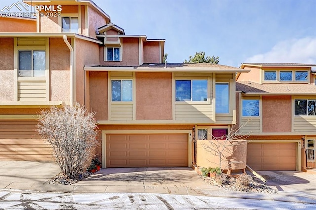 4120 Autumn Heights Dr Unit B, Colorado Springs, CO 80906 - townhome / multi-family property with an attached garage, stucco siding, and concrete driveway