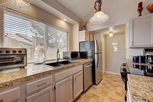 4120 Autumn Heights Dr Unit B, Colorado Springs, CO 80906 - kitchen featuring appliances with stainless steel finishes, tile countertops, pendant lighting, vaulted ceiling, and a textured ceiling