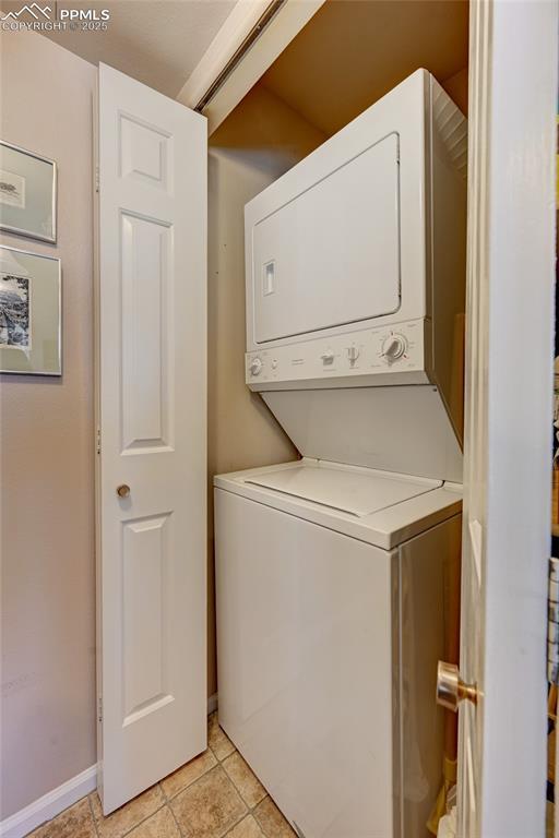 4120 Autumn Heights Dr Unit B, Colorado Springs, CO 80906 - laundry area featuring stacked washing machine and dryer and light tile patterned floors