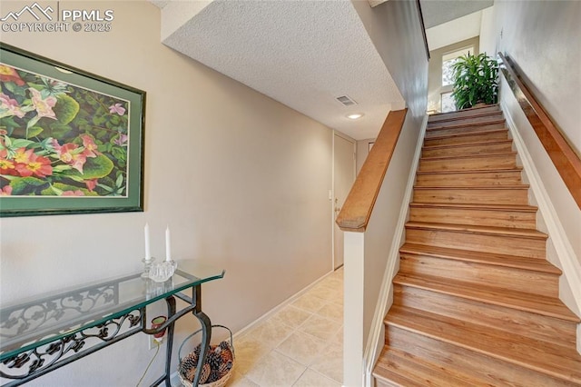 4120 Autumn Heights Dr Unit B, Colorado Springs, CO 80906 - stairs featuring a textured ceiling and tile patterned flooring