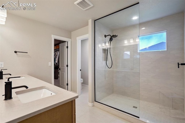 6471 Rolling Creek Dr, Colorado Springs, CO 80924 - full bathroom featuring a shower stall, toilet, double vanity, tile patterned floors, and a walk in closet