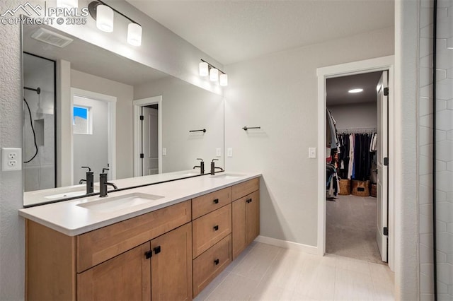 6471 Rolling Creek Dr, Colorado Springs, CO 80924 - bathroom with double vanity, a spacious closet, and baseboards