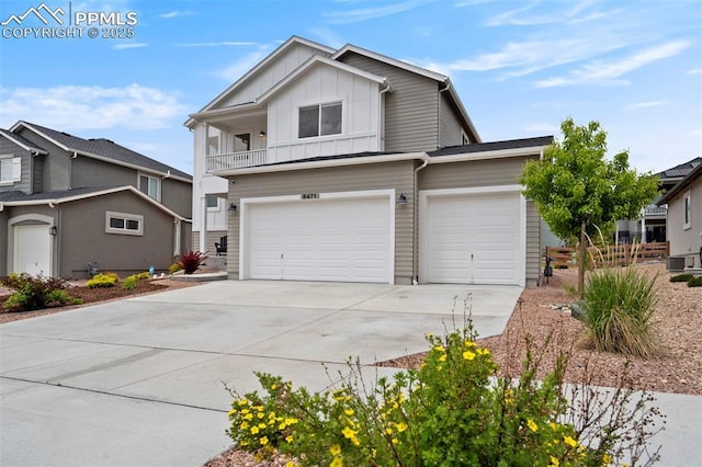 6471 Rolling Creek Dr, Colorado Springs, CO 80924 - view of front of house with board and batten siding, driveway, and a garage
