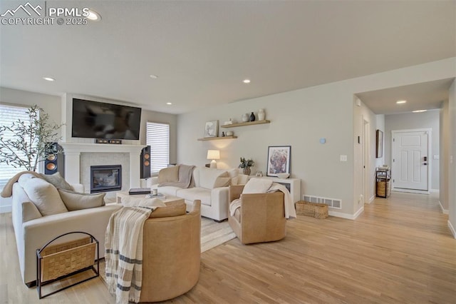 6471 Rolling Creek Dr, Colorado Springs, CO 80924 - living room with light wood-style floors, a glass covered fireplace, recessed lighting, and baseboards