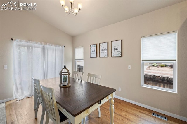 6374 Tramore Way, Colorado Springs, CO 80923 - dining space featuring a chandelier, lofted ceiling, and light wood-style flooring