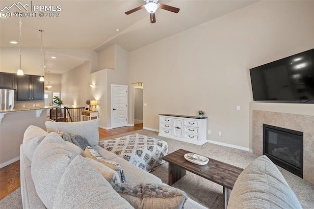 6374 Tramore Way, Colorado Springs, CO 80923 - living area with a ceiling fan, high vaulted ceiling, and a tile fireplace