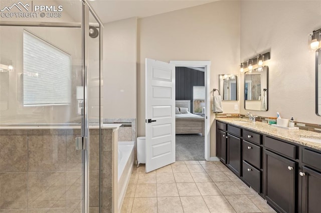 6374 Tramore Way, Colorado Springs, CO 80923 - ensuite bathroom featuring double vanity, tile patterned floors, a garden tub, and a shower stall