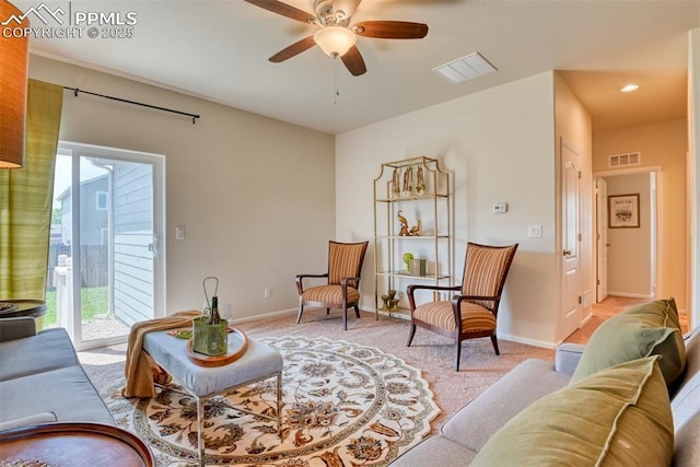 6676 Liberator Trl, Colorado Springs, CO 80925 - living area featuring healthy amount of natural light, a ceiling fan, light carpet, and baseboards