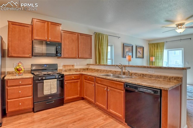 6676 Liberator Trl, Colorado Springs, CO 80925 - kitchen featuring black appliances, a sink, a peninsula, ceiling fan, and healthy amount of natural light