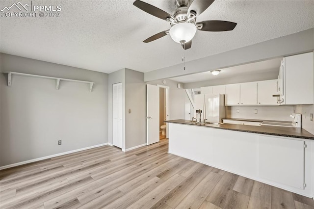 2013 Erin Loop, Colorado Springs, CO 80918 - kitchen featuring white fridge with ice dispenser, dark countertops, light wood finished floors, a ceiling fan, and a textured ceiling